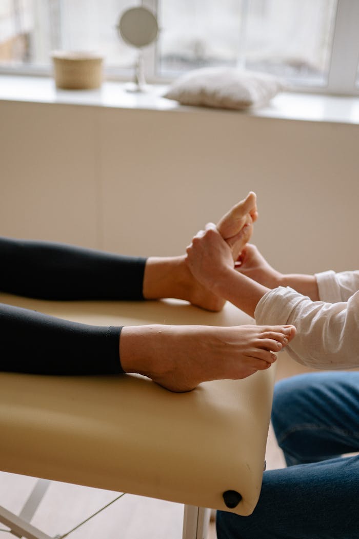 Mastering the First Impression: Your intriguing post title goes here A professional massage therapist providing foot reflexology on a comfortable massage table.