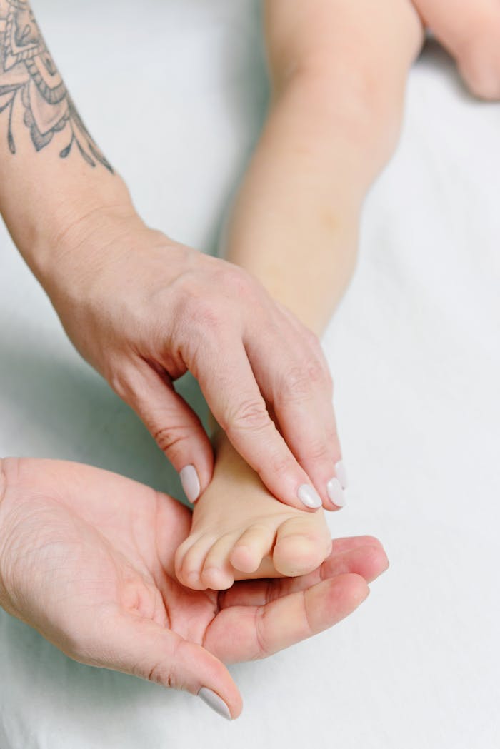 Crafting Captivating Headlines: Your awesome post title goes here Gentle foot massage therapy for baby relaxation and wellness.